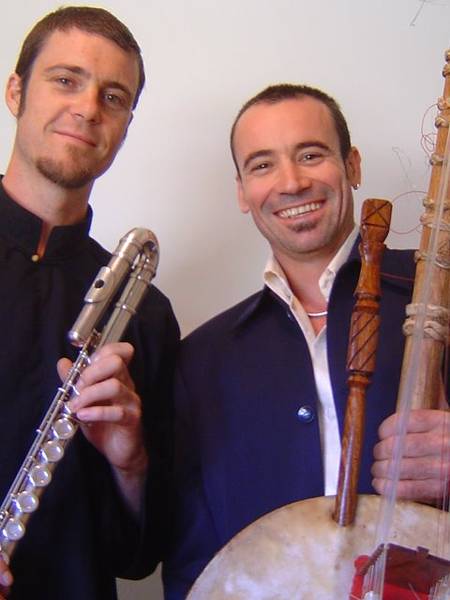 Two men holding flute and kora