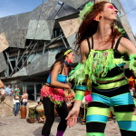 Beautiful dancers in costume in front of interesting building at Federation Square