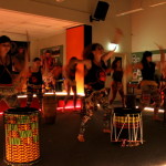 Dancers playing dunduns (African stick drums)